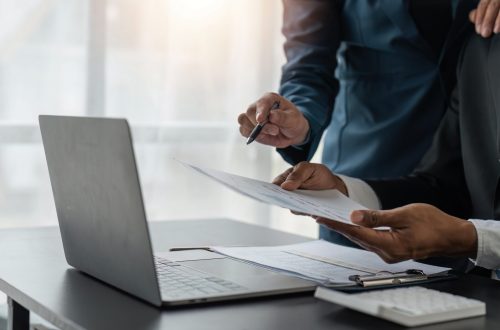 Meeting business team advisor about financial graph chart showing results are analyzing and use calculating with calculator planning strategy.